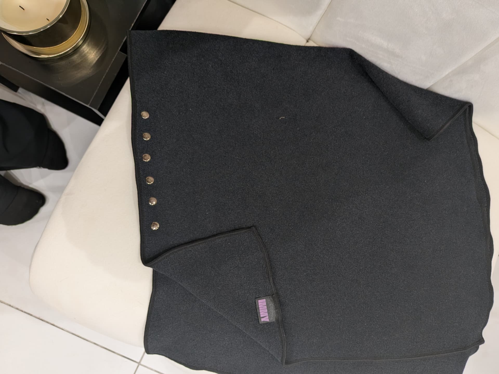The IMMY Towel laid flat showing its GripLock press studs and lilac label